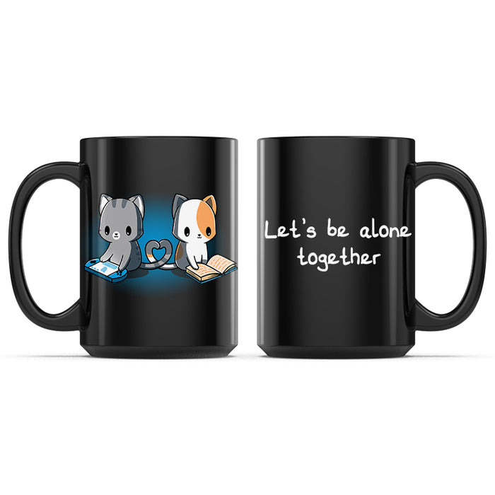 Ceramic Mug_TeeTurtle Let's Be Alone Together black mug featuring a cat playing video games, and a cat reading a book with their tails forming a heart between them.
